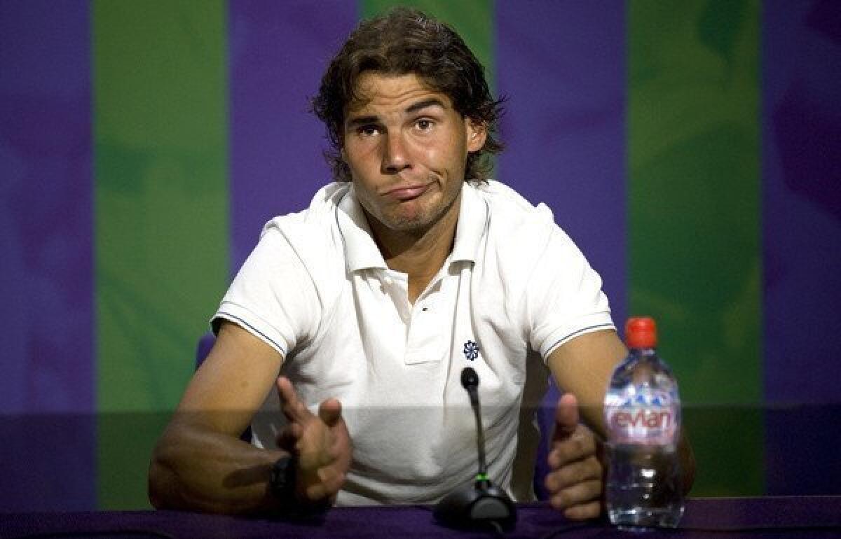 Rafael Nadal addresses the media after his second-round loss at Wimbledon. He hasn't played since because of knee problems, and now he has postponed his return to the court because of a stomach virus.