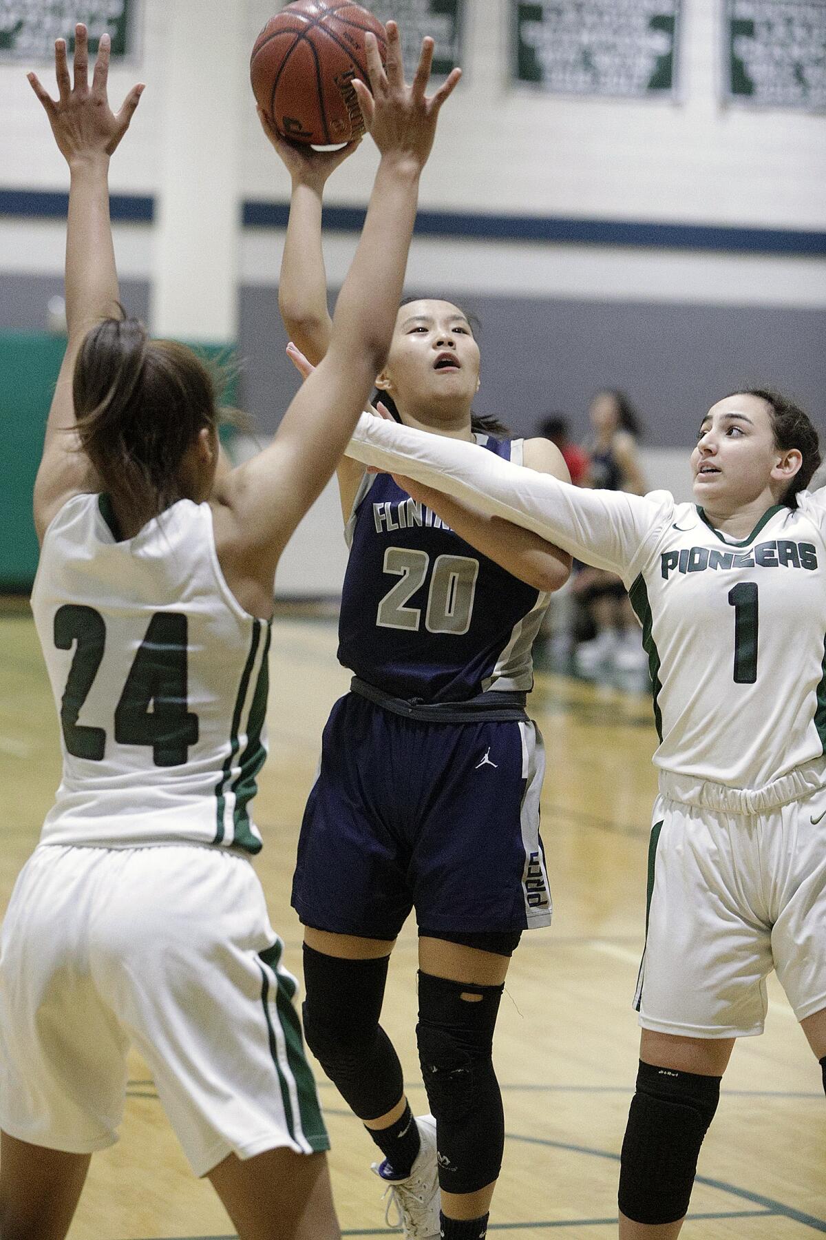 Flintridge Prep's Ashlyn Zhang drives into the lane and shoots against Providence's Sophie Nazarian and Ava Tibbs in a Prep League girls' basketball game at Providence High School on Friday, January 10, 2020.