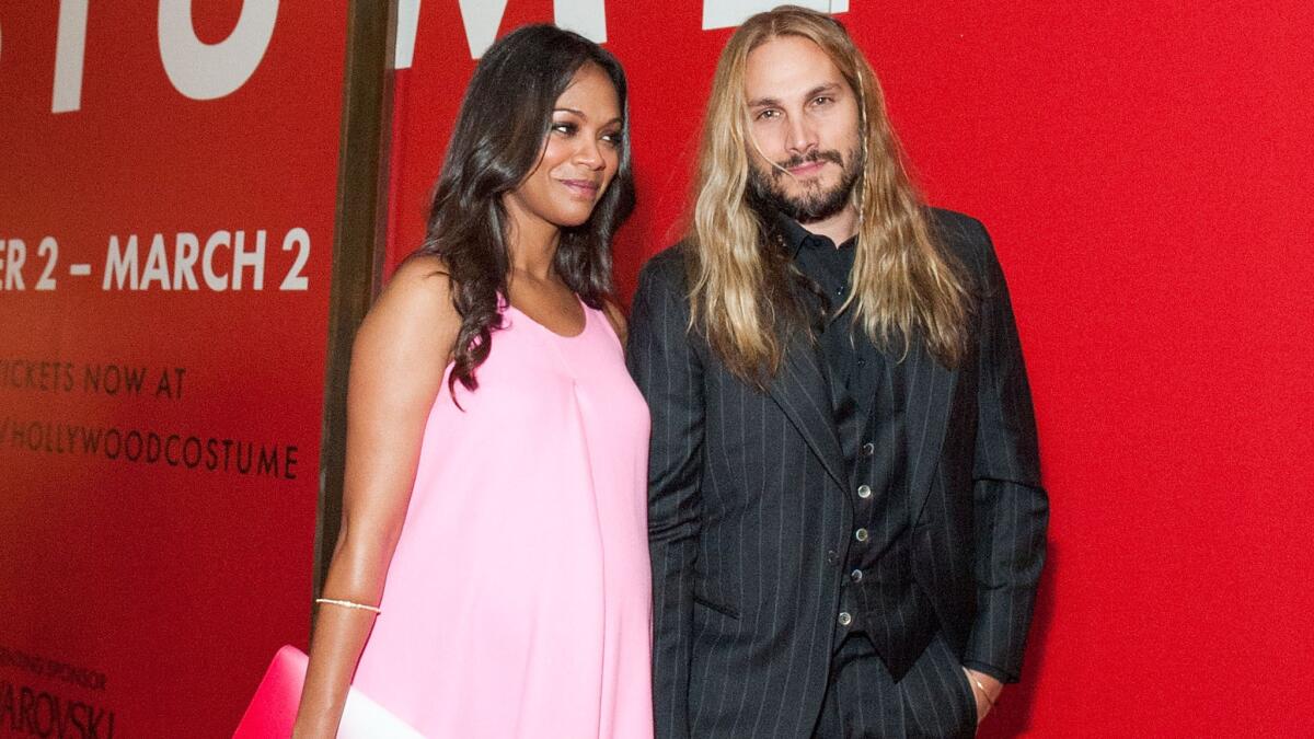 Zoe Saldana and husband Marco Perego attend the Academy of Motion Picture Arts and Sciences' "Hollywood Costume" opening party at the Wilshire May Company Building on Wednesday.