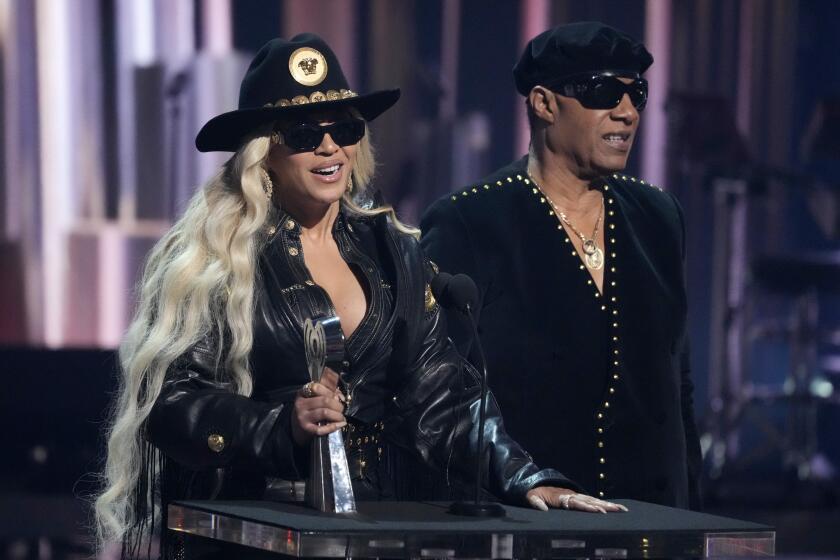 Beyonce and Stevie Wonder appear onstage together to accept an award