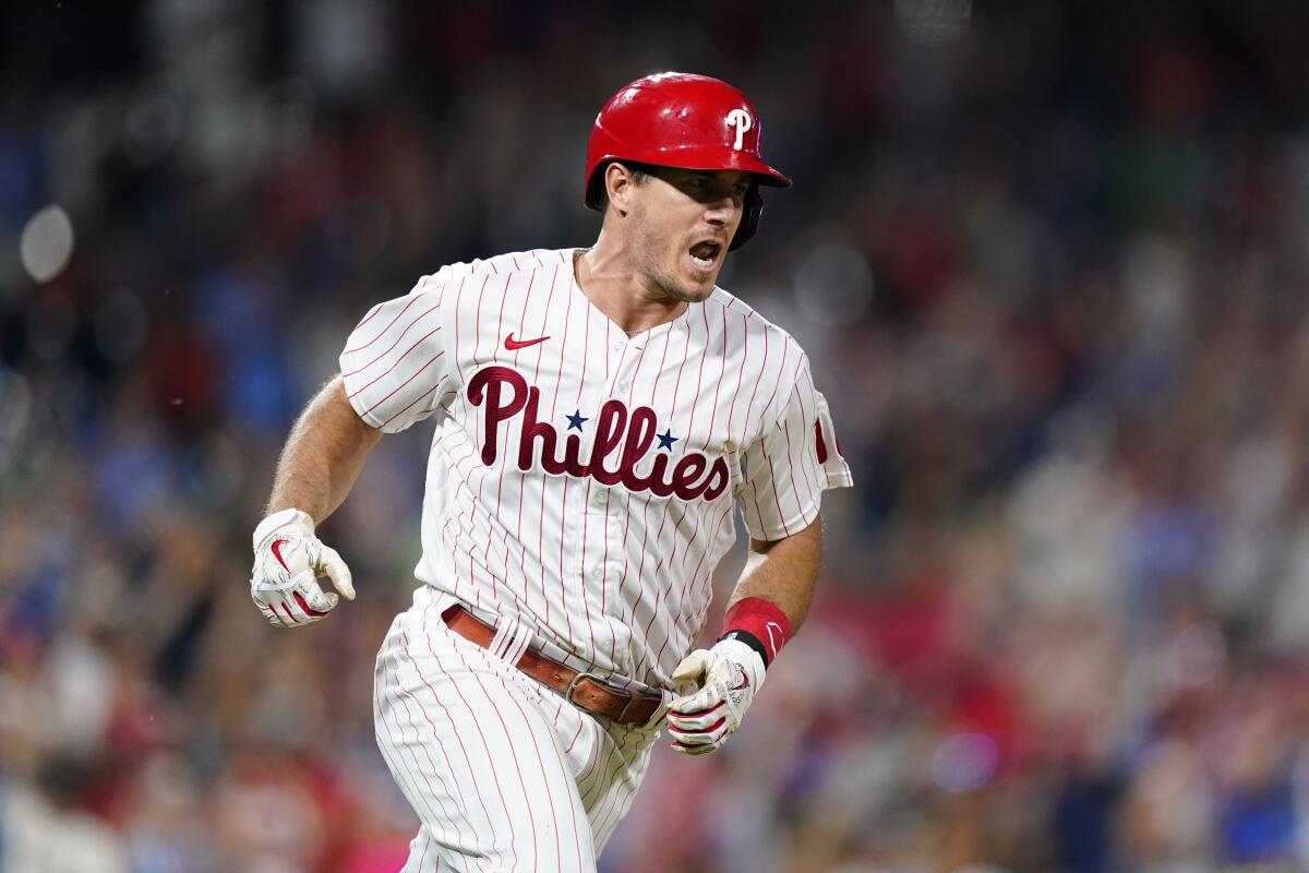 Philadelphia Phillies' J.T. Realmuto reacts after hitting a run-scoring single against Miami Marlins pitcher Sandy Alcantara during the eighth inning of a baseball game, Wednesday, Aug. 10, 2022, in Philadelphia. (AP Photo/Matt Slocum)