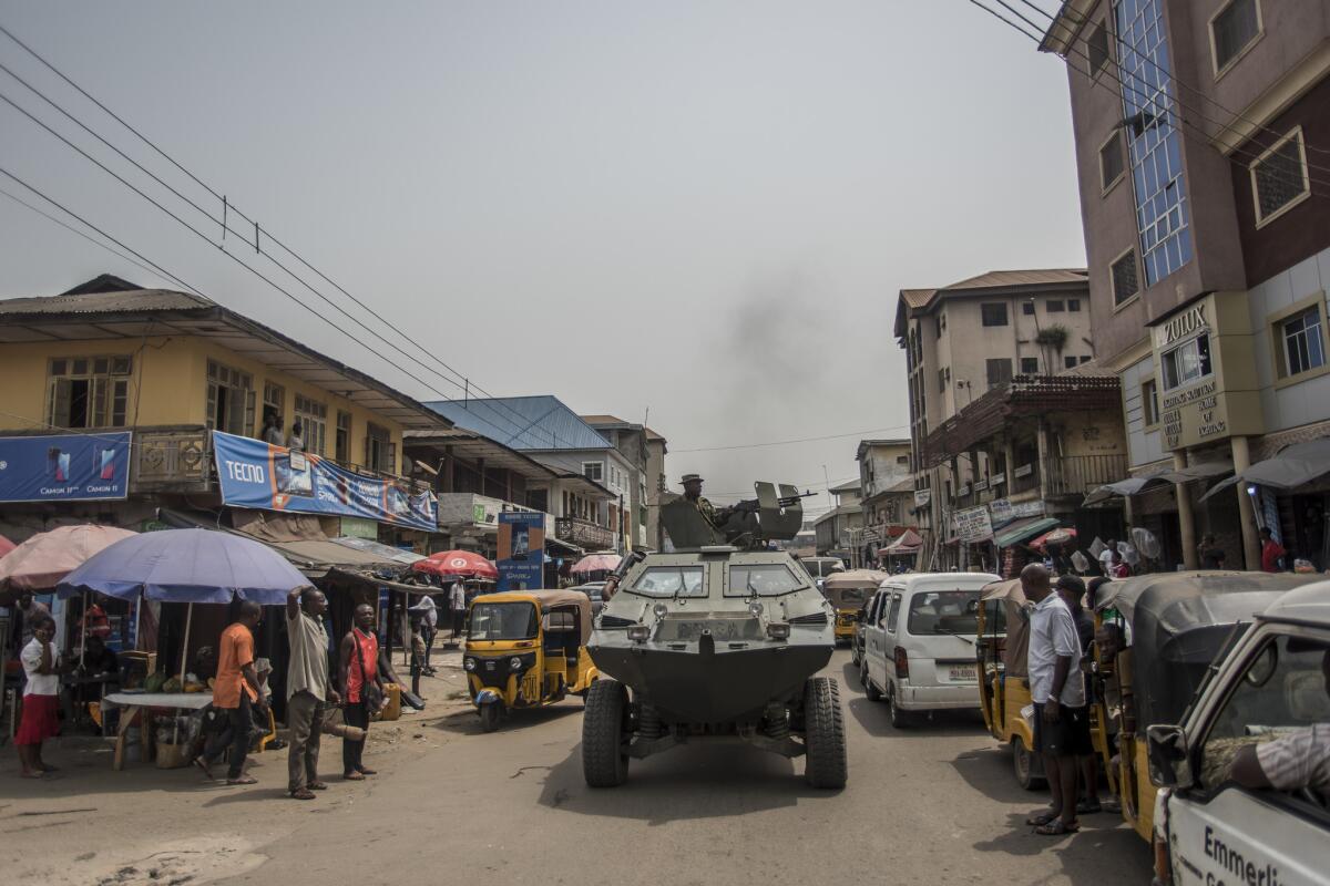 A Nigerian army tank moves along a street in a pro-Biafra separatist zone in Aba.