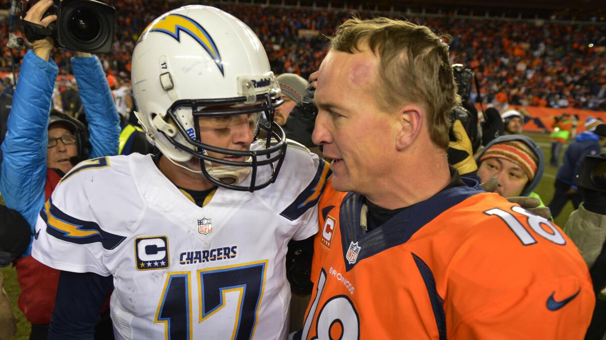 San Diego Chargers quarterback Philip Rivers, left, speaks with Denver Broncos quarterback Peyton Manning after the Broncos' playoff win last season.