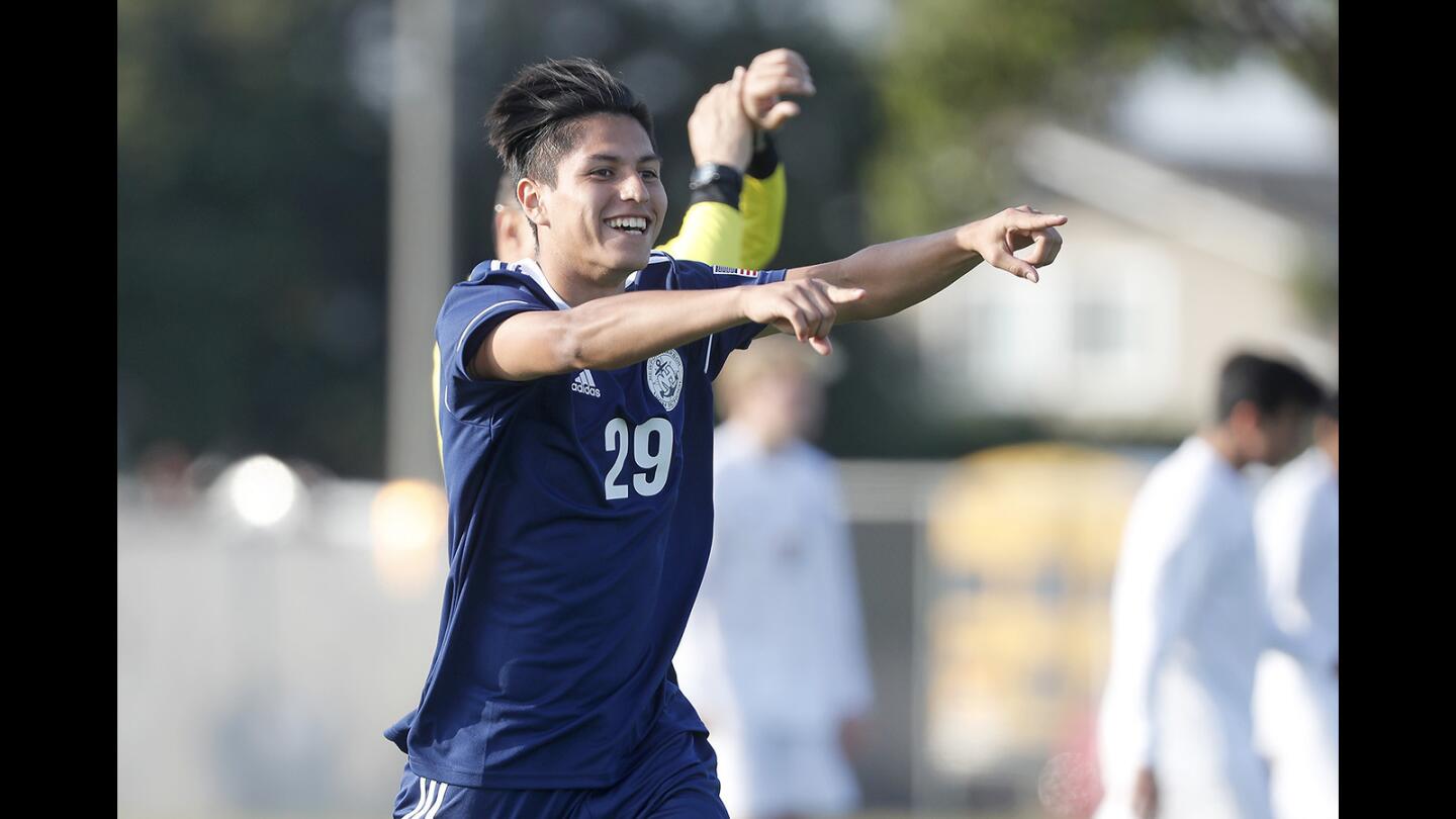 Newport Harbor High's Angel Ariza points towards the Sailors' bench after scoring in the first minute of the game against Fountain Valley in a Sunset League match on Wednesday.