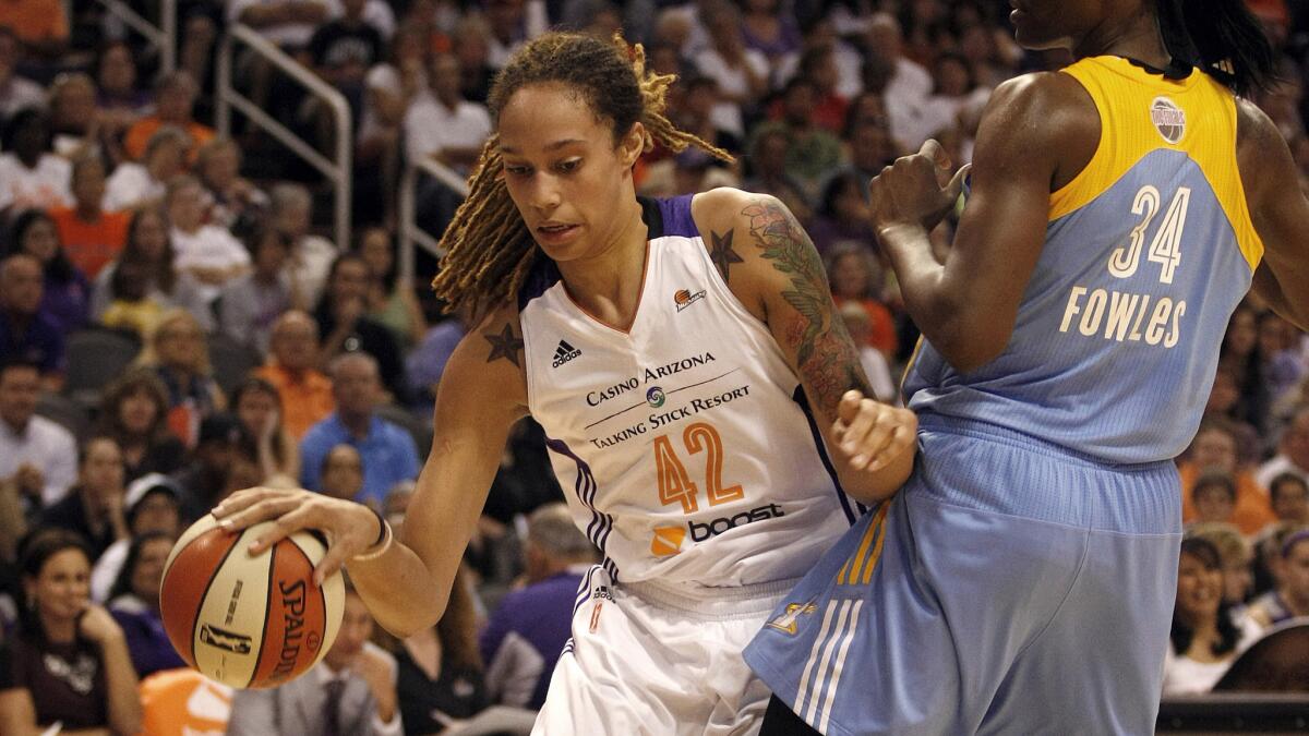 Phoenix Mercury center Brittney Griner, left, drives on Chicago Sky center Sylvia Fowles during the first half of Phoenix's 83-62 win in Game 1 of the WNBA Finals on Sunday.