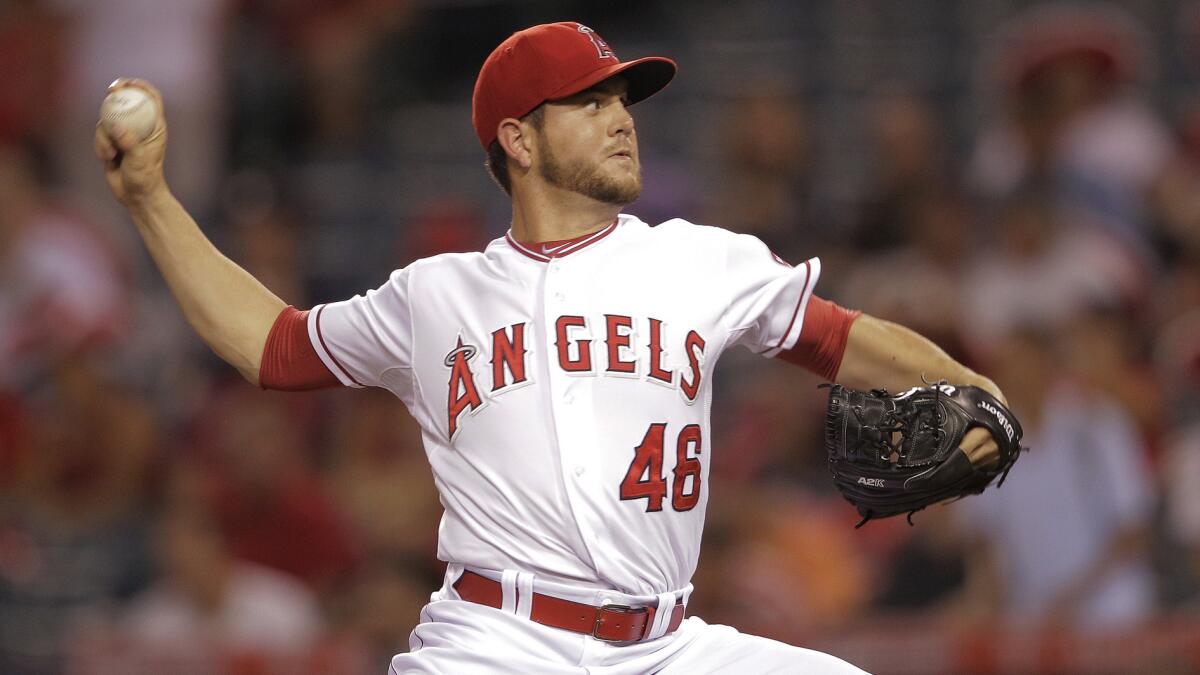 Angels starter Cory Rasmus delivers a pitch in the first inning of a 13-2 loss to the Seattle Mariners in Anaheim on Sept. 16.