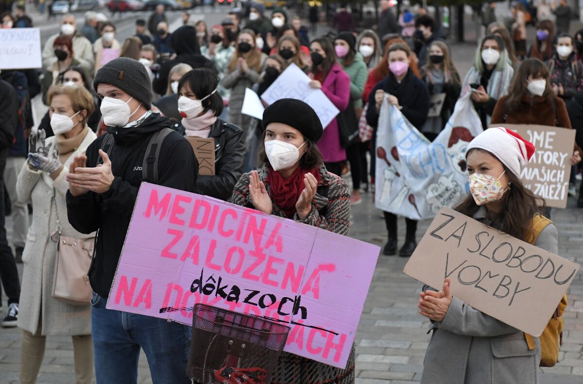 In this picture taken on Oct. 20. 2021 in Kosice Slovakia, people protest against proposed bill that tightens access to abortion. The banner left says "Medicine based on evidence" banner right: "For freedom of choice". On Thursday Nov. 11. 2021 Lawmakers have rejected the bill submitted by conservative lawmakers for the Ordinary People, the senior party in the coalition government led by Prime Minister Eduard Heger. (Frantisek Ivan/TASR via AP)