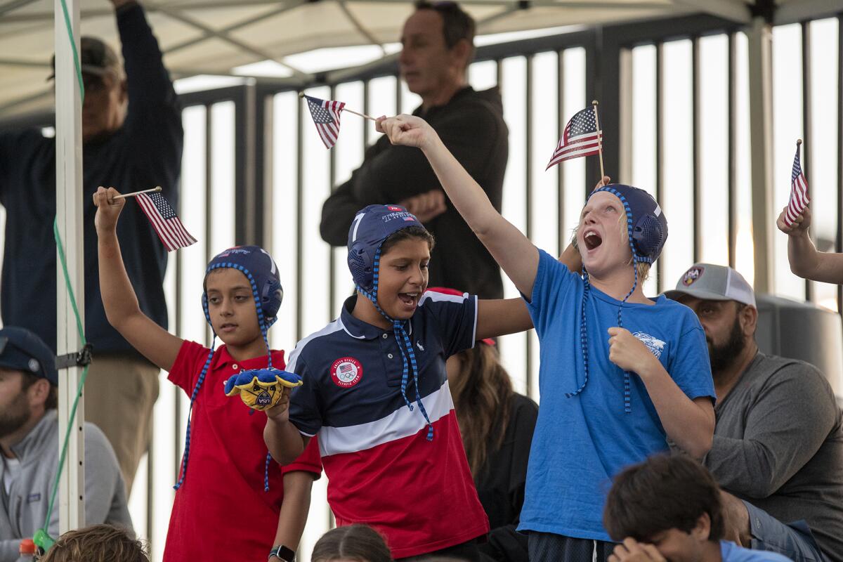 Young fans cheer for Team USA water polo during an exhibition game against Italy on Tuesday.