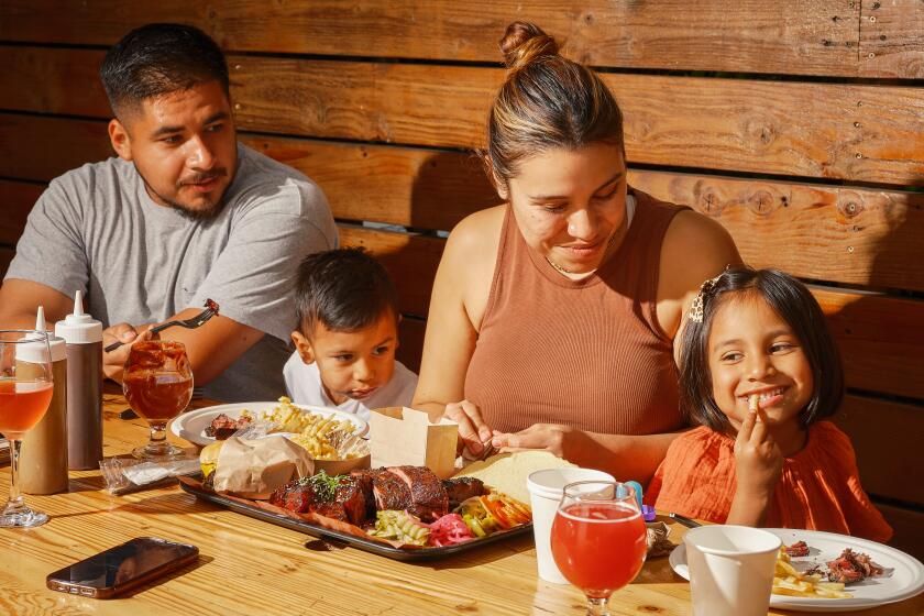 LOS ANGELES , CA - OCTOBER 01: (From Left) Dianna Castellanos and Gabriel Miranda dine at Moo's Craft Barbecue on Saturday, Oct. 01 2022 in Los Angeles , CA. (Shelby Moore / For The Times)