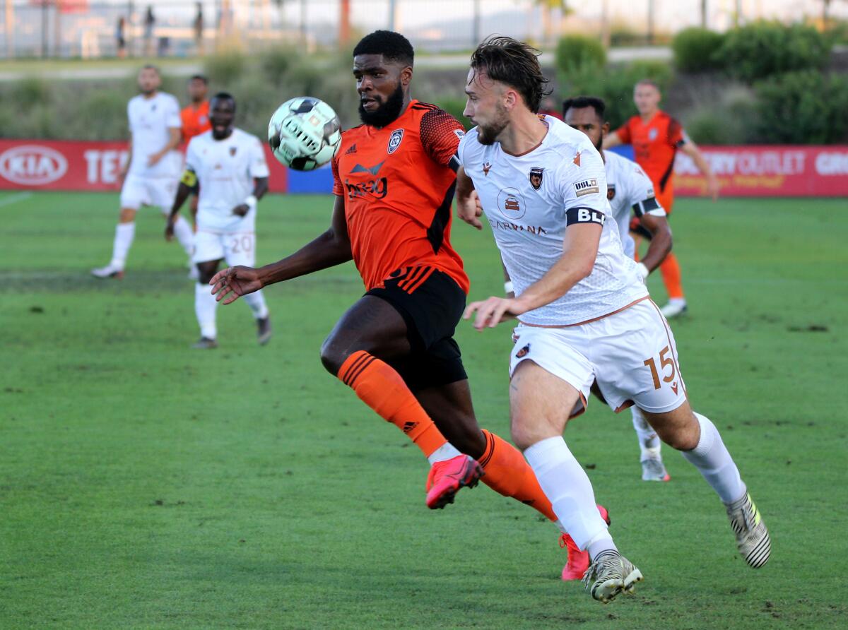 Orange County Soccer Club's Sean "Ugo" Okoli, left, battles against defender Joe Ferrell  versus Phoenix  on July 25.
