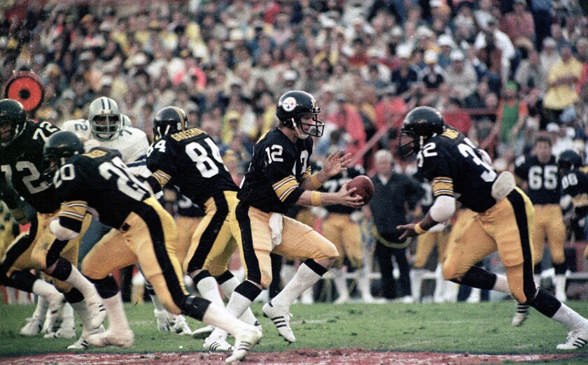 Pittsburgh Steelers quarterback Terry Bradshaw turns around to hand the ball off to running back Franco Harris during Super Bowl XIII on Jan. 21, 1979.