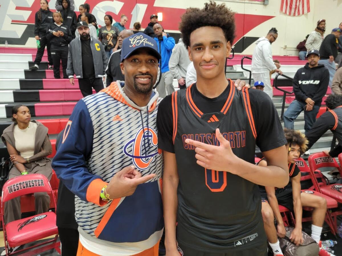  Gilbert and Alijah Arenas smile and point to each other.