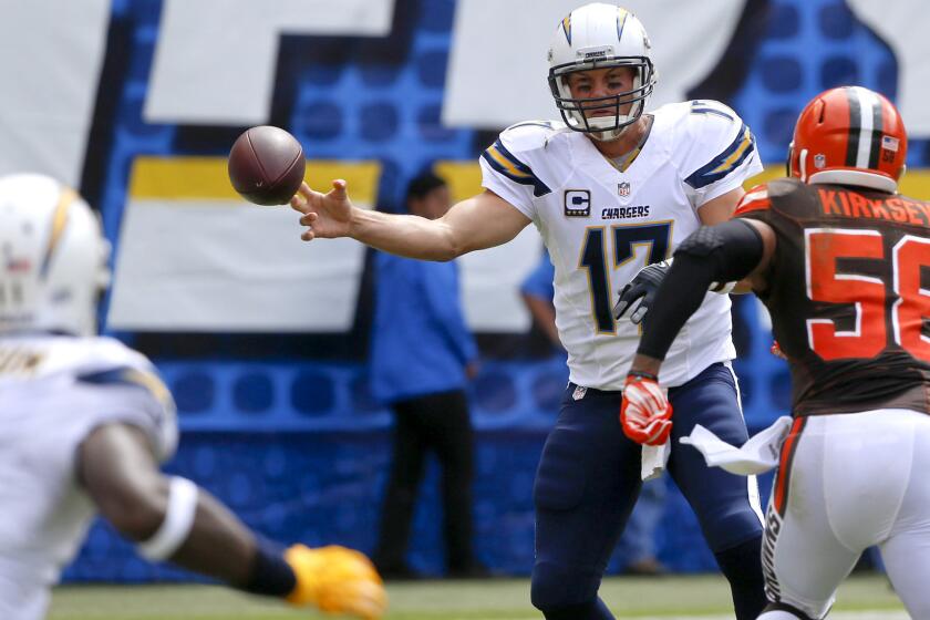 Chargers quarterback Philip Rivers slings a pass around Browns linebacker Christian Kirksey on Sunday.