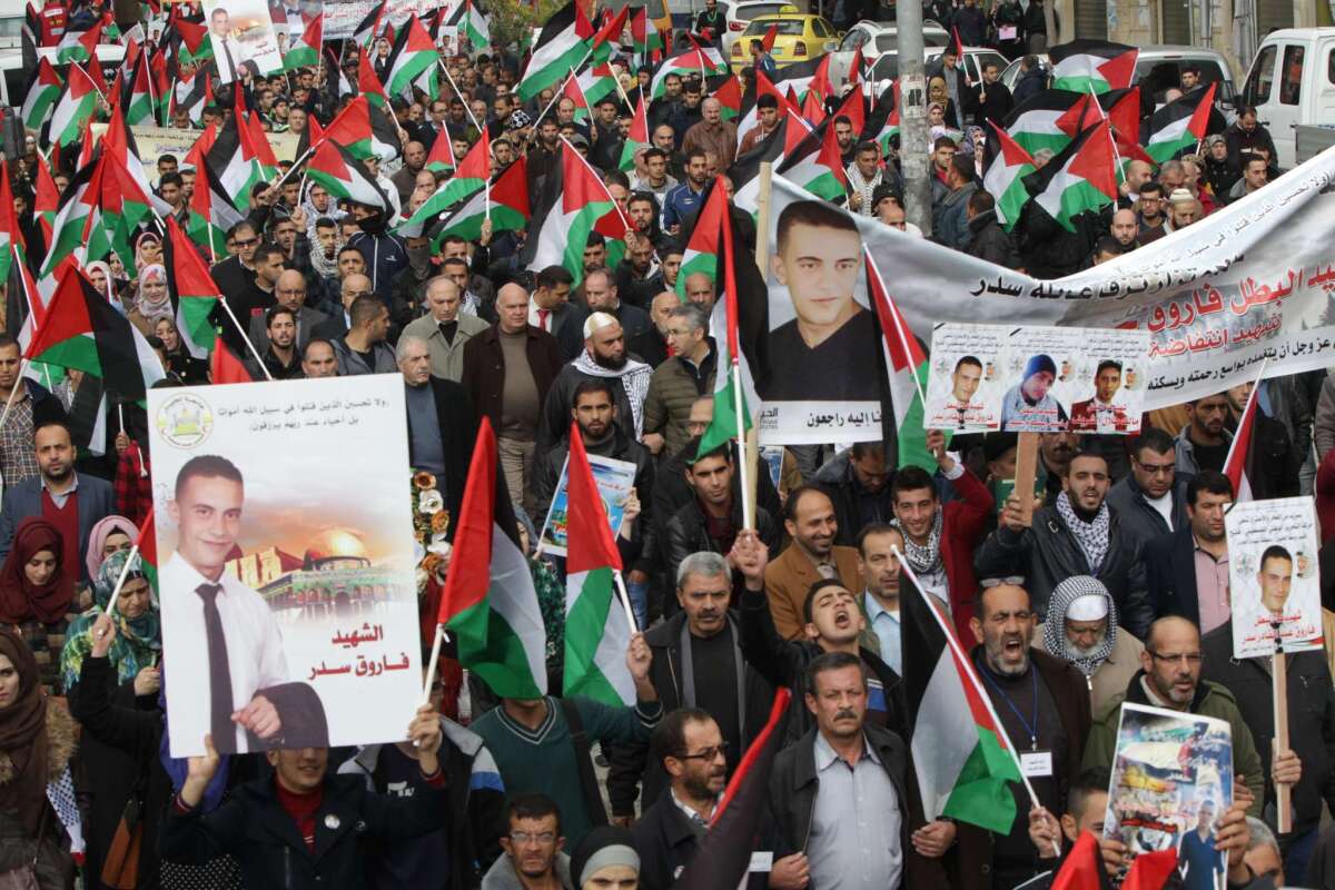 Protesters hold posters of Palestinians who have been shot dead during attacks on Israelis as they take part in a demonstration to demand Israeli authorities the return of their bodies, on November 10, in the West Bank town of Hebron.