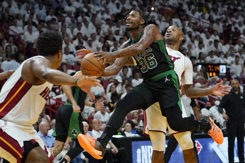 Boston Celtics guard Marcus Smart (36) drives to the basket as Miami Heat forward P.J. Tucker defends during the second half of Game 5 of the NBA basketball Eastern Conference finals playoff series, Wednesday, May 25, 2022, in Miami. (AP Photo/Lynne Sladky)