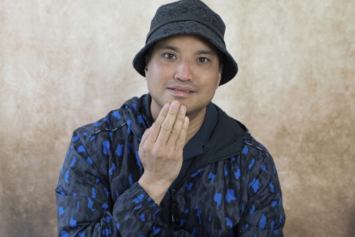 Chad Hugo, of the music production team The Neptunes, does the sign for thank you as he poses for a portrait in New York on May 22, 2022. Hugo and Pharrell Williams will be inducted into the Songwriters Hall of Fame on Thursday. (AP Photo/Gary G. Hamilton)