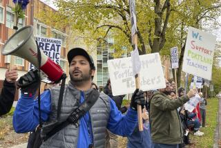 Teachers and their supporters hold signs, chant and rally the crowd with bullhorns on the first day of a teacher's strike in Portland, Ore., Wednesday, Nov. 1, 2023. The Portland Association of Teachers said its first-ever strike in the district stemmed from concerns over large class sizes, salaries that haven't kept up with inflation and a lack of resources. (AP Photo/Claire Rush)