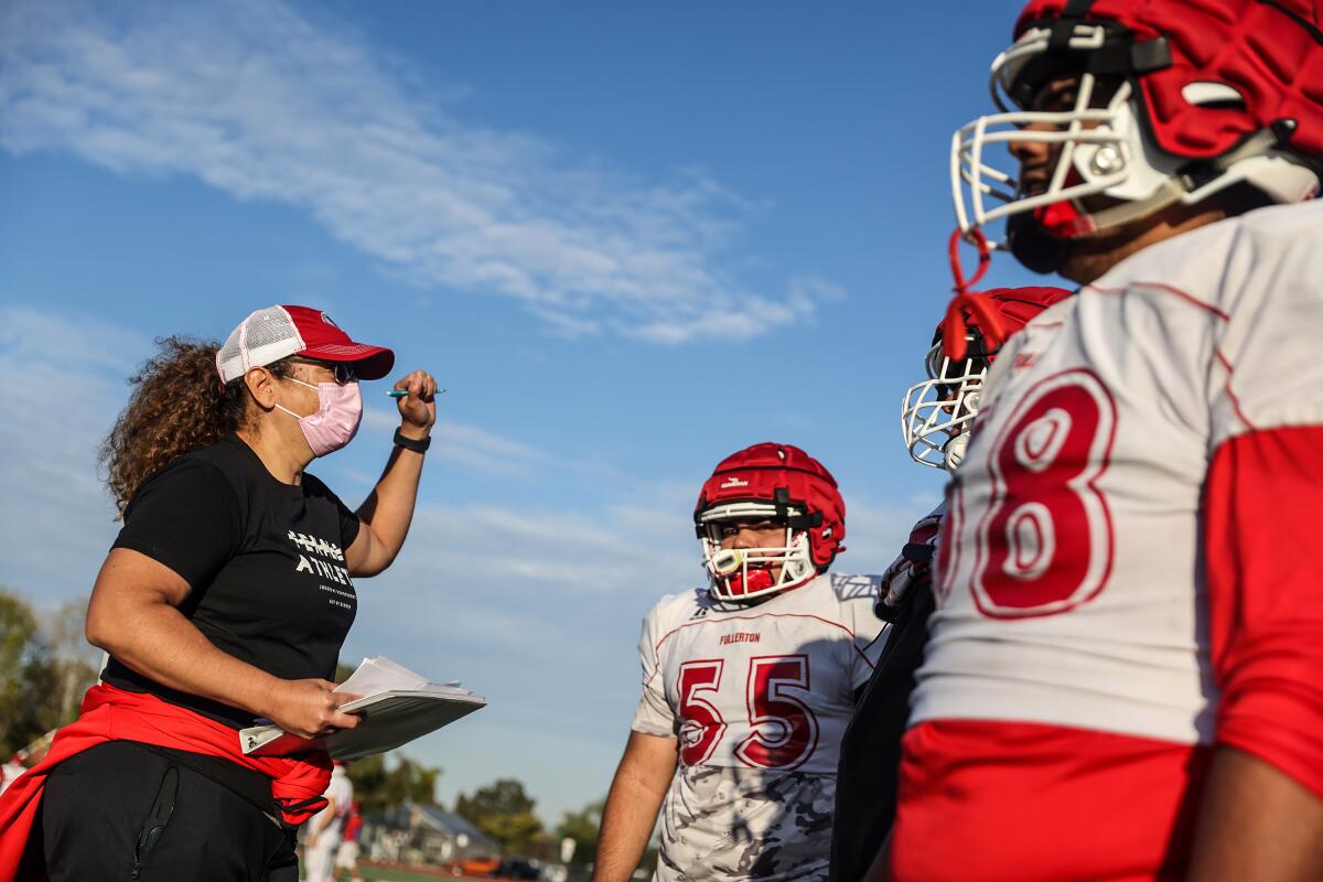Herminia Hall talks to Fullerton High football players during a recent practice.