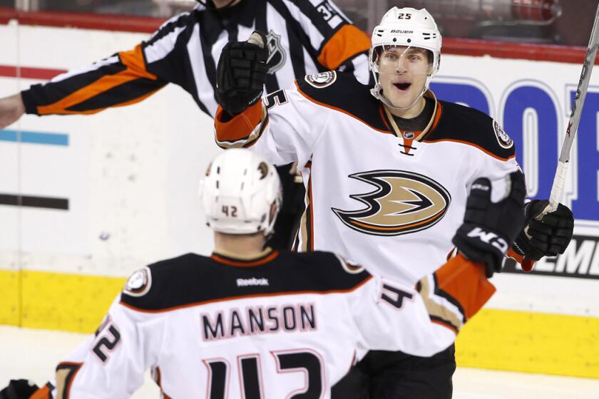 Anaheim Ducks' Mike Santorelli, right, celebrates with Josh Manson his goal against the Calgary Flames during third period on Monday.