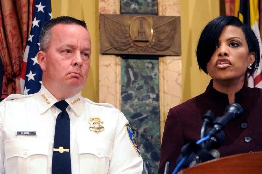 Baltimore Police Commissioner Kevin Davis and Mayor Stephanie Rawlings-Blake at a news conference at City Hall on Aug. 10.