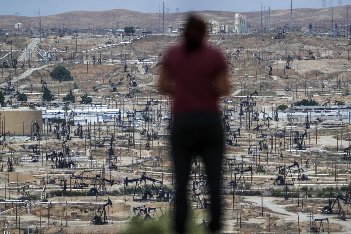A person looks over Chevron's immense Kern River Oil Field north of Bakersfield in May.