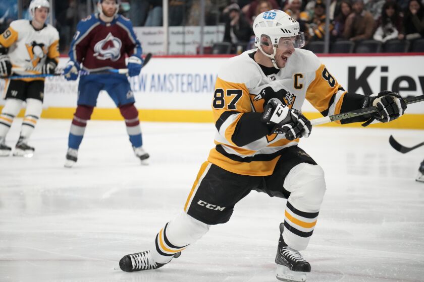 Pittsburgh Penguins center Sidney Crosby reacts after scoring a goal against the Colorado Avalanche in the second period of an NHL hockey game Wednesday, March 22, 2023, in Denver. (AP Photo/David Zalubowski)