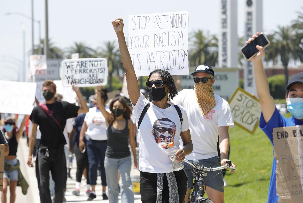 Marcia Brown and other protesters march from the Fashion Island entrance during a Black Lives Matter protest.