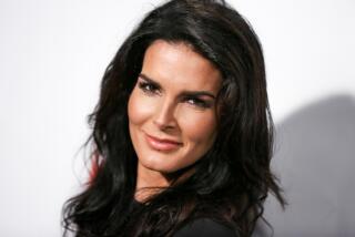 Angie Harmon smiles while looking slightly over her left shoulder