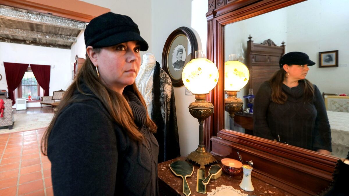 Paranormal researcher Nicole Strickland in the master bedroom of the Rancho Buena Vista Adobe in Vista. She leads monthly "Spirits of the Adobe" tours at the historic Vista property and recently published a book on the adobe's ghostly inhabitants.