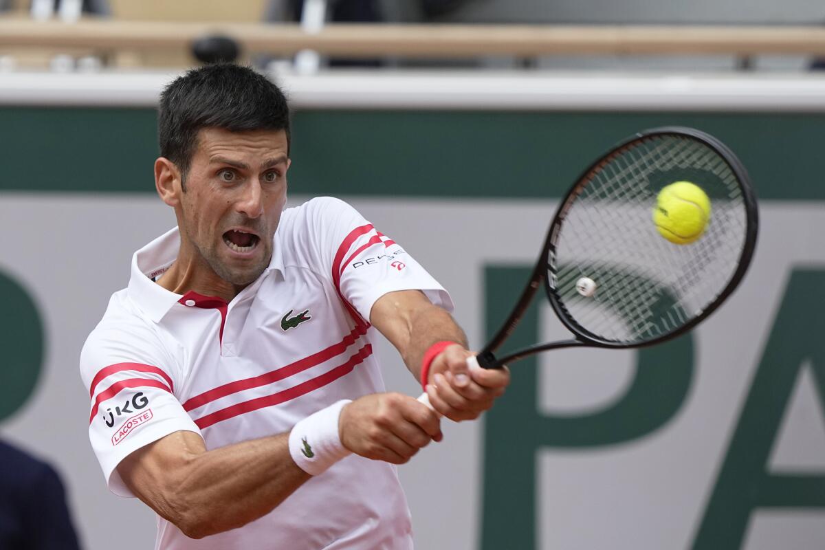 Novak Djokovic plays a return to Lorenzo Musetti.