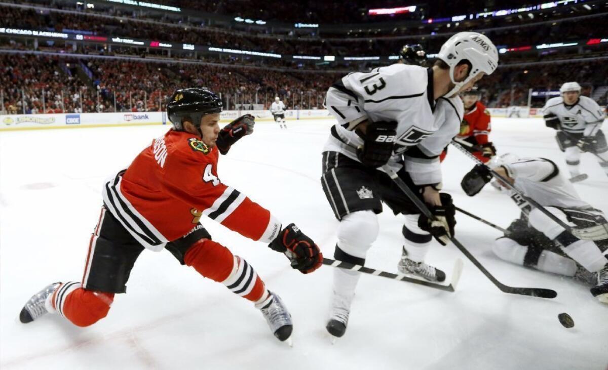 Chicago Blackhawks defenseman Niklas Hjalmarsson (4) battles Kings center Tyler Toffoli for a loose puck during a game on March 25.