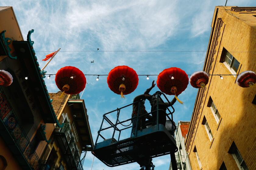 SAN FRANCISCO-CA-JANUARY 14, 2022: Old lanterns are replaced with new, larger ones in San Francisco's Chinatown on Wednesday, January 14, 2022. (Christina House / Los Angeles Times)