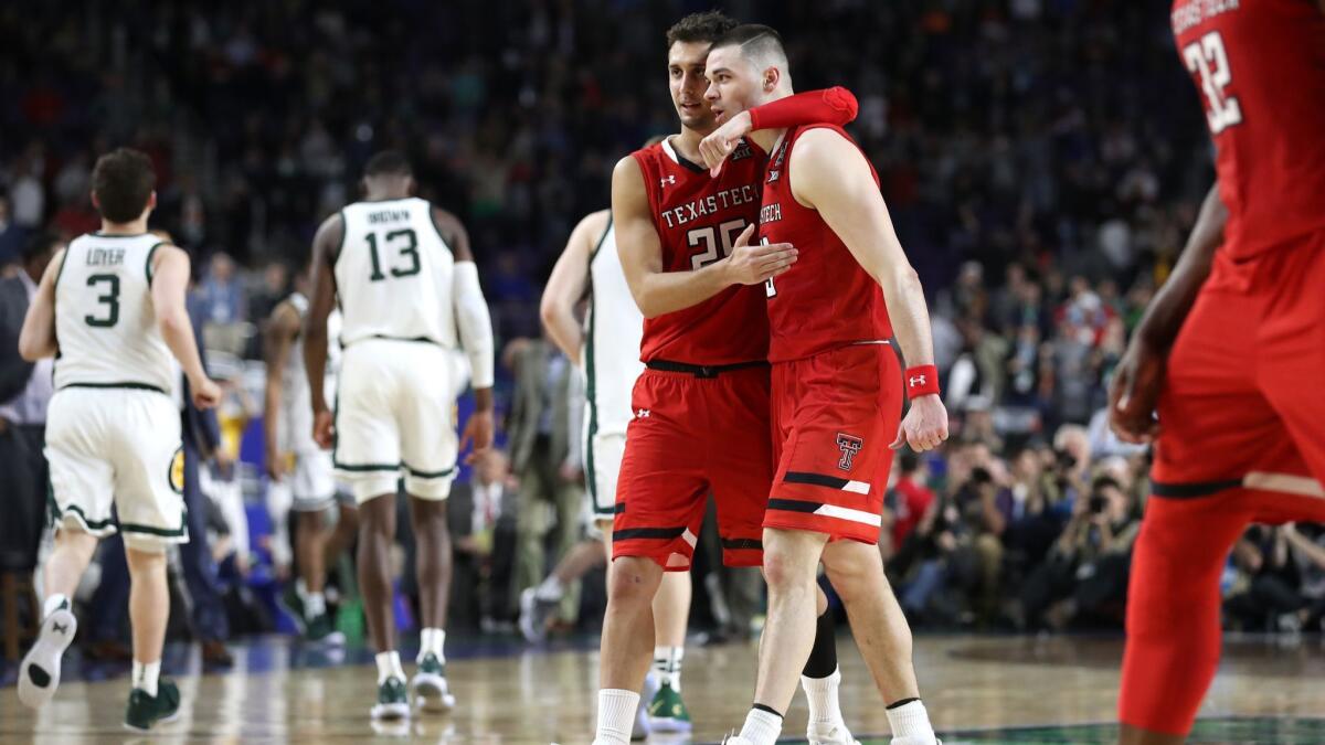 Texas Tech's Davide Moretti (25) and Matt Mooney (13) react in the second half after beating Michigan State during the NCAA Final Four on Saturday in Minneapolis.