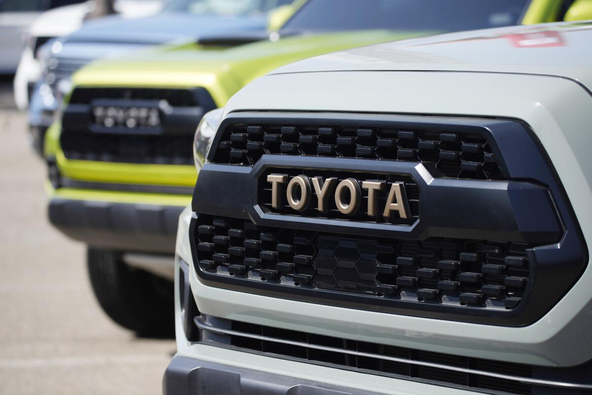 FILE - The company logo highlights the grille of a 2021 Tacoma pickup truck on display in the Toyota exhibit at the Denver auto show Friday, Sept. 17, 2021, at Elitch's Gardens in downtown Denver. Toyota reported a 64% drop in fiscal third quarter profit Thursday, Feb. 9, 2023, as a global shortage of chips and soaring raw material costs battering the auto industry hit Japan’s top automaker. (AP Photo/David Zalubowski, File)