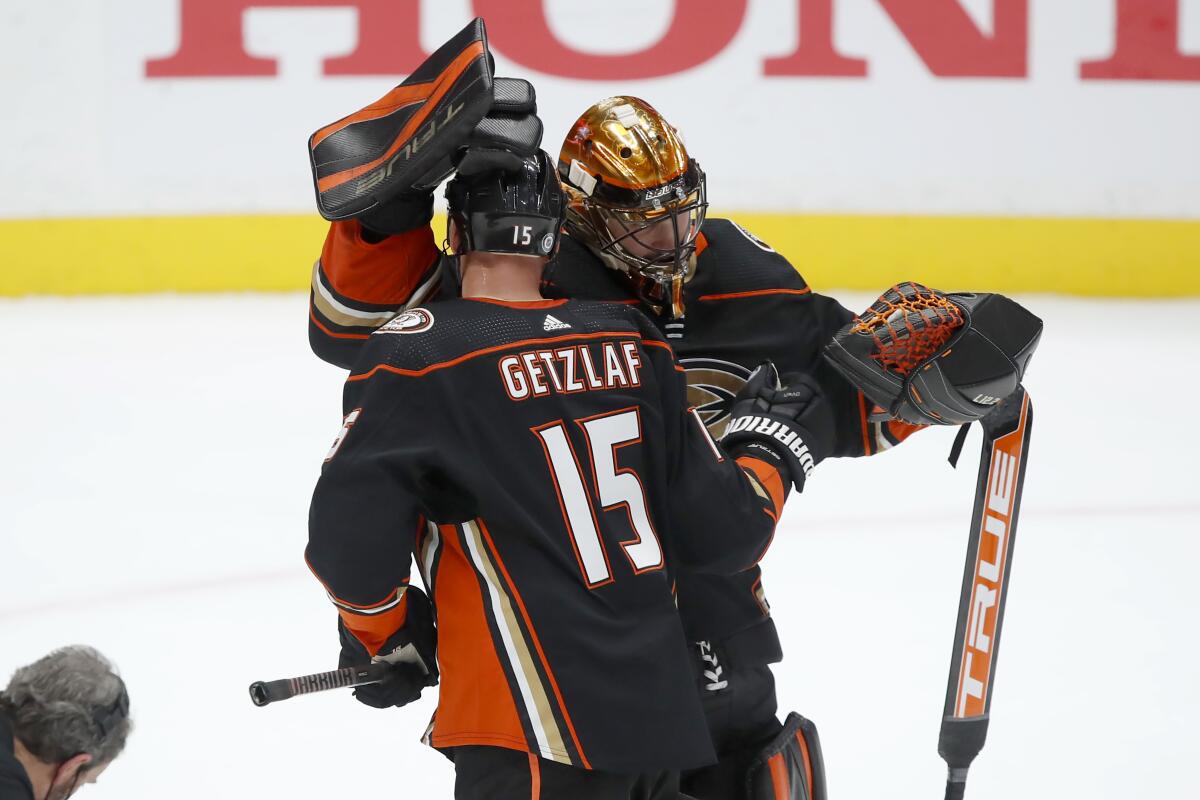 Ducks center Ryan Getzlaf, left, congratulates goaltender Anthony Stolarz after the Ducks' 4-1 win.