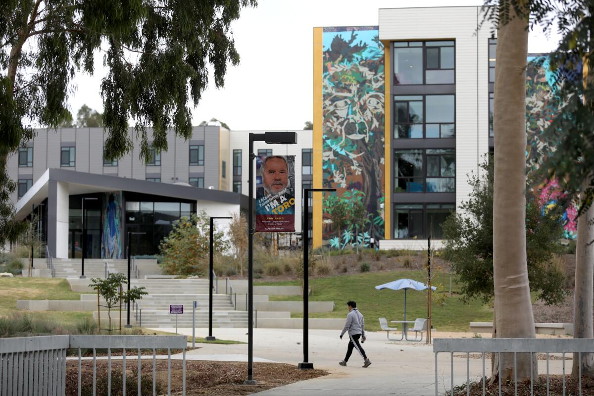 A student walks on a college campus.