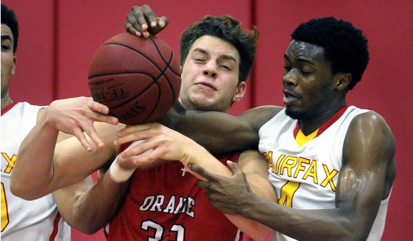 Orange Lutheran's Zac Jervi battles for the rebound from Fairfax's Isaiah Hartwell during their Open Division regional playoff game on Friday.