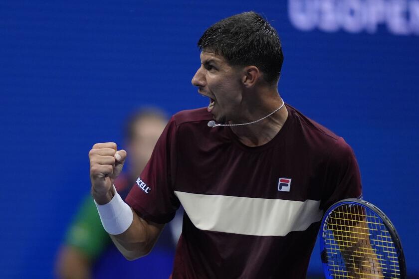 Alexei Popyrin, of Australia, reacts against Novak Djokovic, of Serbia, during a third round match.