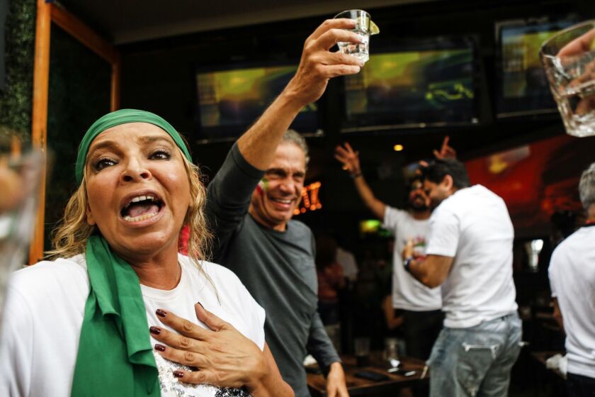 LOS ANGELES, CA -- FRIDAY, JUNE 15, 2018-- Mandy Molesten, left, cheers with a shot of tequila after the finale of the Iranian v Morocco game of the World Cup. (Maria Alejandra Cardona / Los Angeles Times)