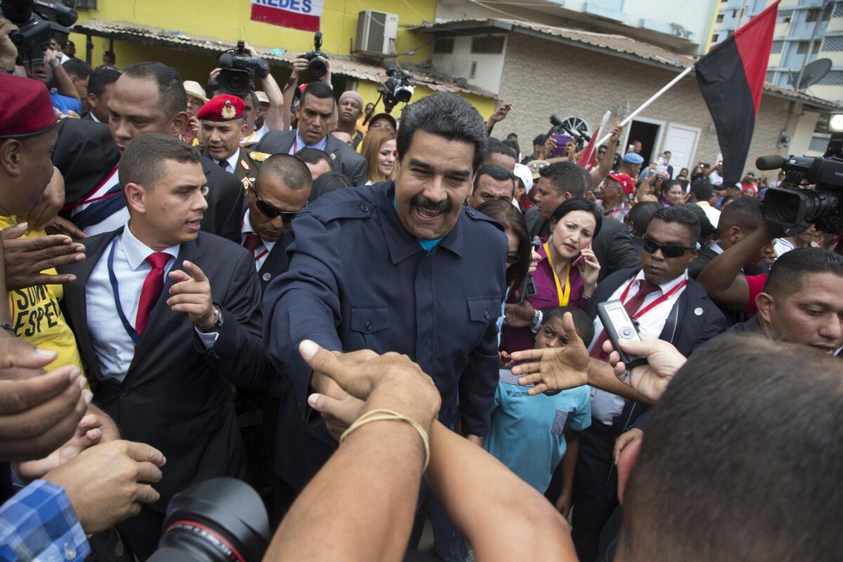 Venezuelan President Nicolas Maduro greets supporters before a ceremony at a monument for those who died during the 1989 U.S. invasion of Panama in the Chorrillo neighborhood in Panama City on April 10.