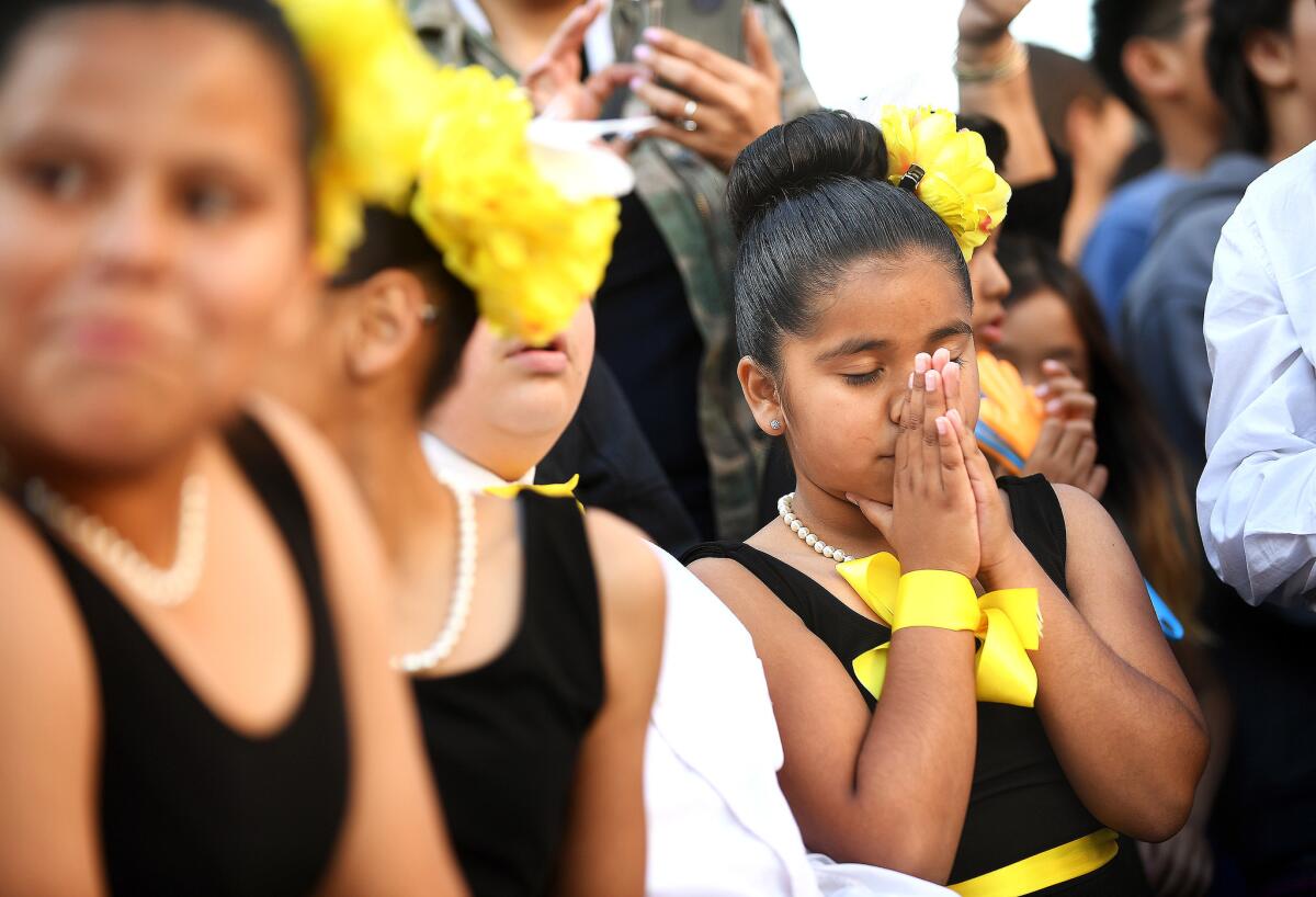 Estrella student Maria Nava, right, and her fellow dancers anxiously wait for the advancing teams to be announced in the contest at L.A. Live downtown.