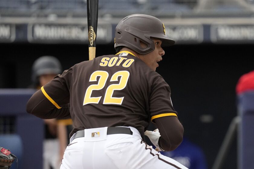 San Diego Padres' Juan Soto bats during the first inning of a spring training baseball game against the Texas Rangers Wednesday, March 1, 2023, in Peoria, Ariz. (AP Photo/Charlie Riedel)