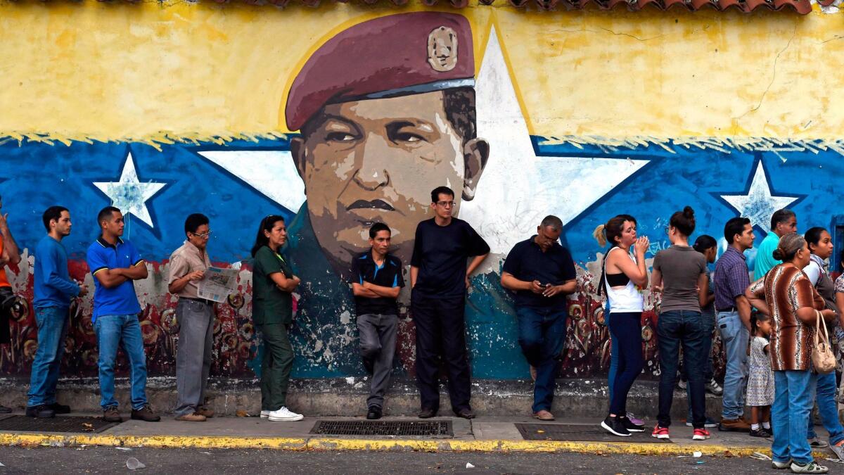 Venezuelans line up outside a polling station during regional elections in Caracas, Venezuela, on Oct. 15, 2017.