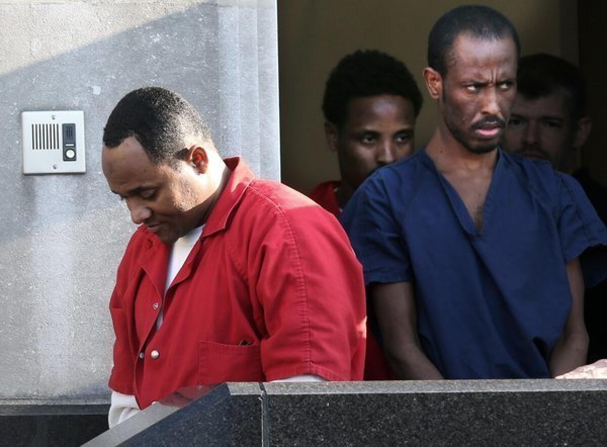 Shani Nurani Shiekh Abrar, left, and Ahmed Muse Salad, right leave the federal courthouse in Norfolk, Va., in June. The two men and a third Somali pirate, Abukar Osman Beyle, were sentenced Friday in the 2011 shooting deaths of four Americans off the coast of Africa. *