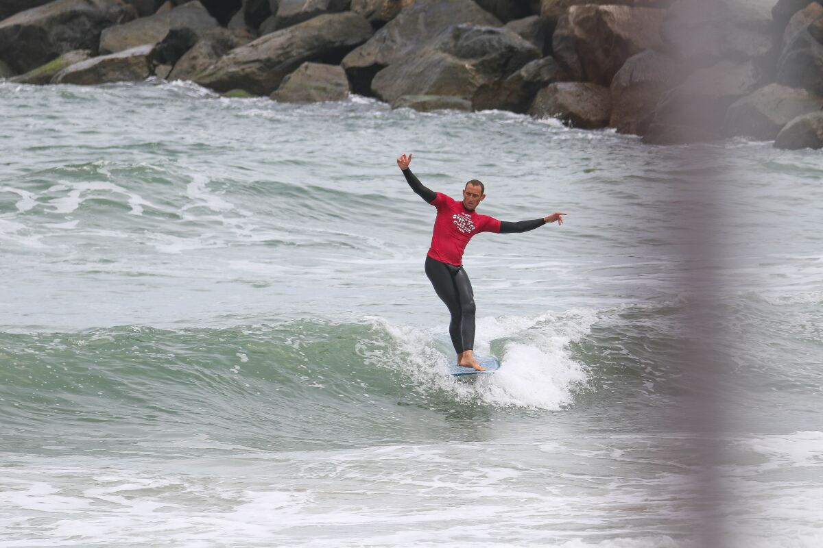 Richie Cravey surfs in the quarterfinal round of the Coastal Edge Steel Pier Classic.