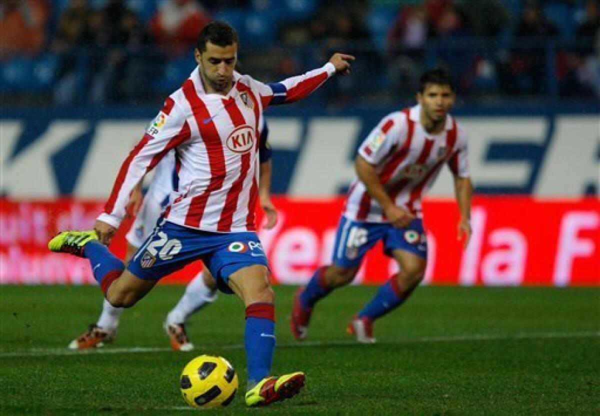 Atletico de Madrid's Simao Sabrosa from Portugal shoots a penalty during his Spanish Copa del Rey soccer match against Espanyol at the Vicente Calderon stadium in Madrid, Wednesday, Dec. 22, 2010. (AP Photo/Arturo Rodriguez)