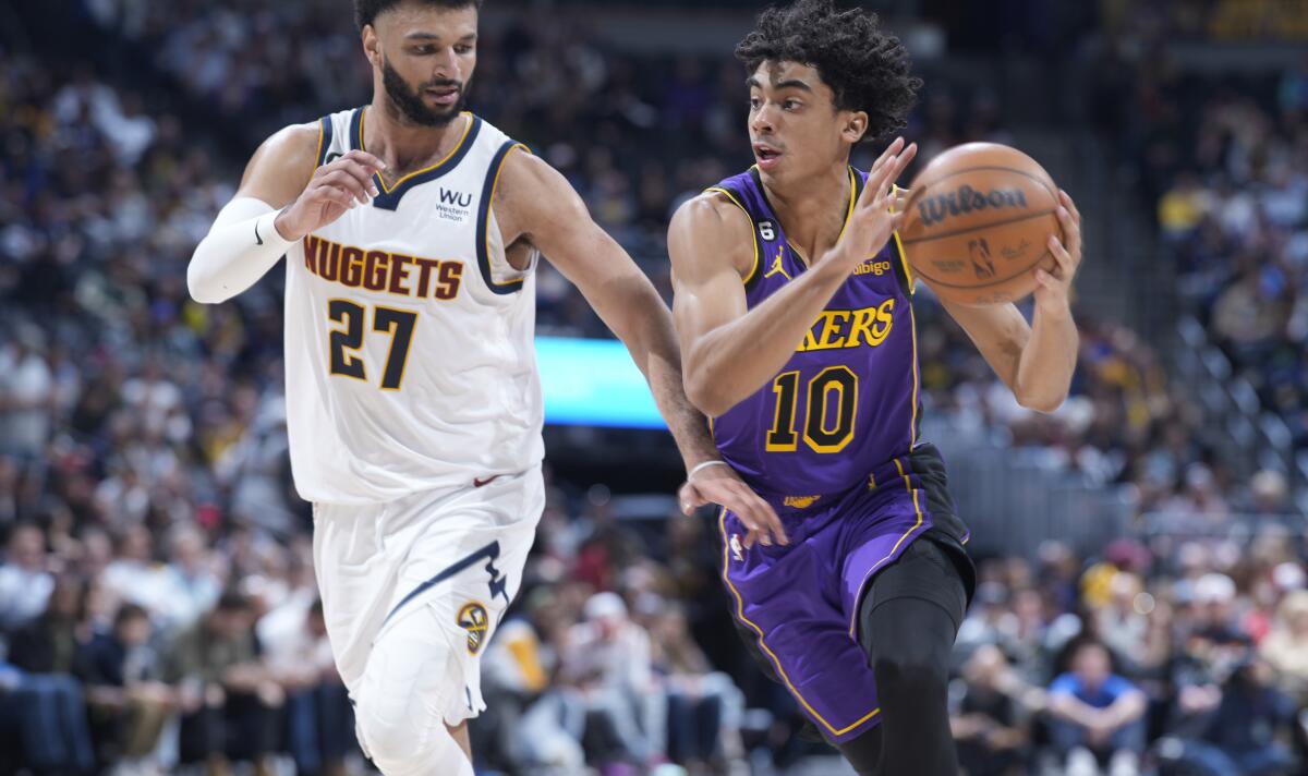Lakers guard Max Christie, right, drives to the basket past Nuggets guard Jamal Murray.