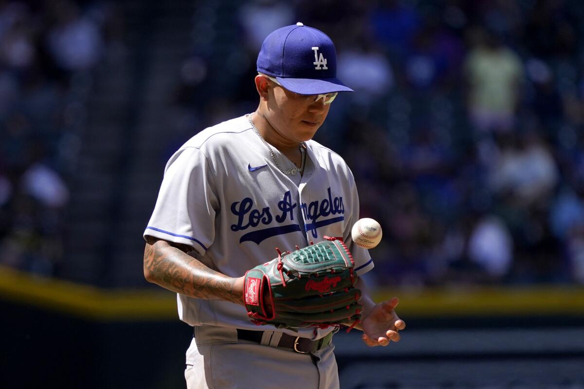 Dodgers pitcher Julio Urías tosses the baseball after giving up a home run against the Arizona Diamondbacks.