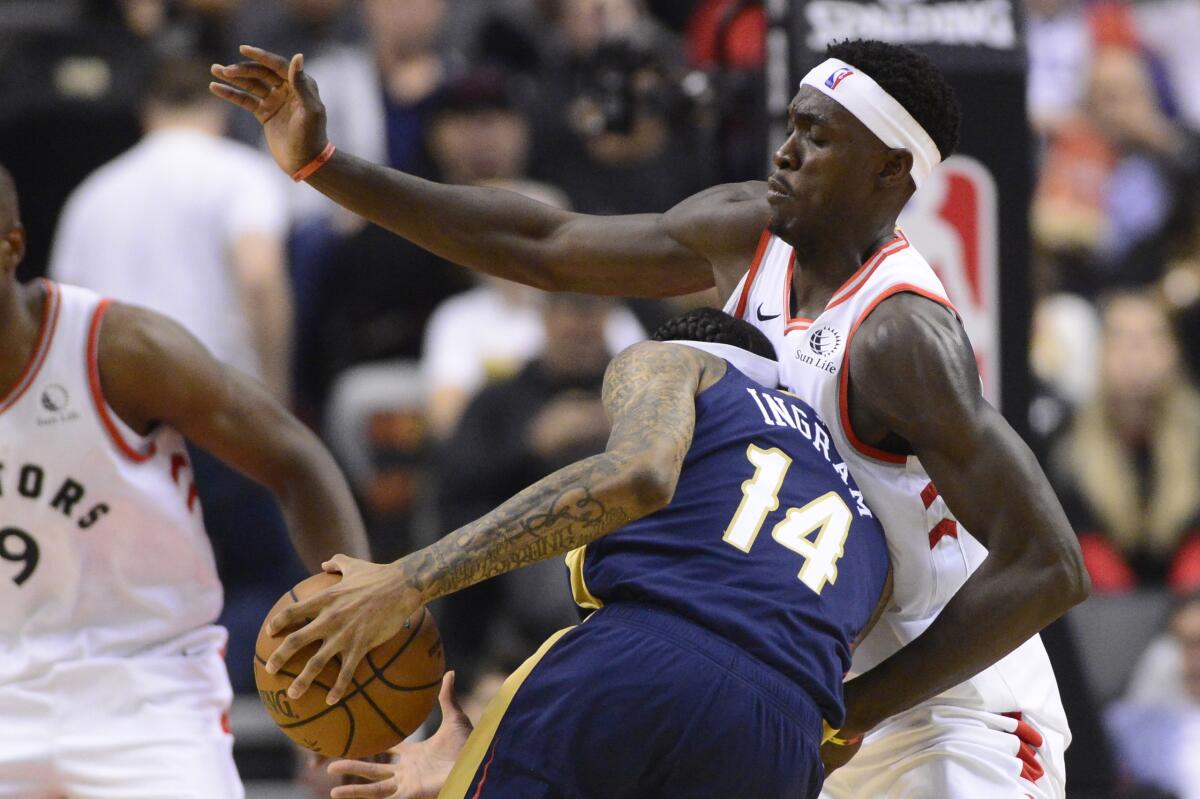 Pelicans forward Brandon Ingram tries to drive past Raptors forward Pascal Siakam during the first half Tuesday in Toronto.