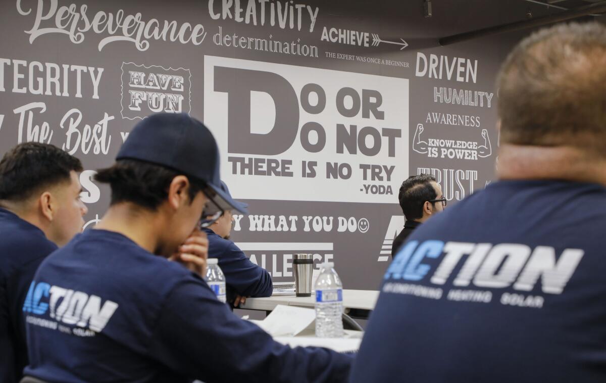 Inspirational messages are displayed on a wall of the Action Academy trade school classroom at Action Air.